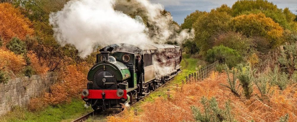a train on a track with smoke coming out of it
