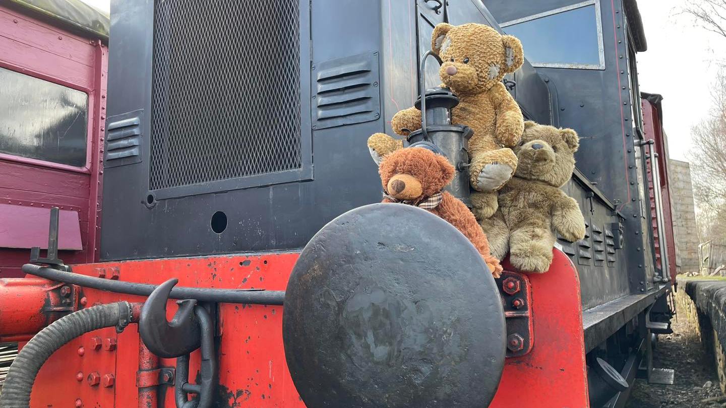 a train is parked on the side of a building