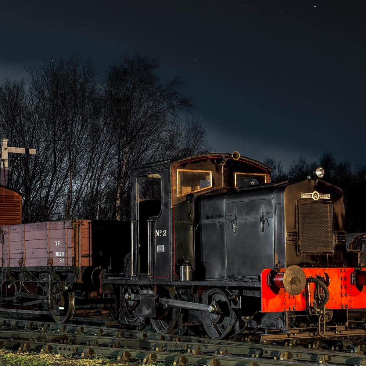 a train engine carrying carts down a track