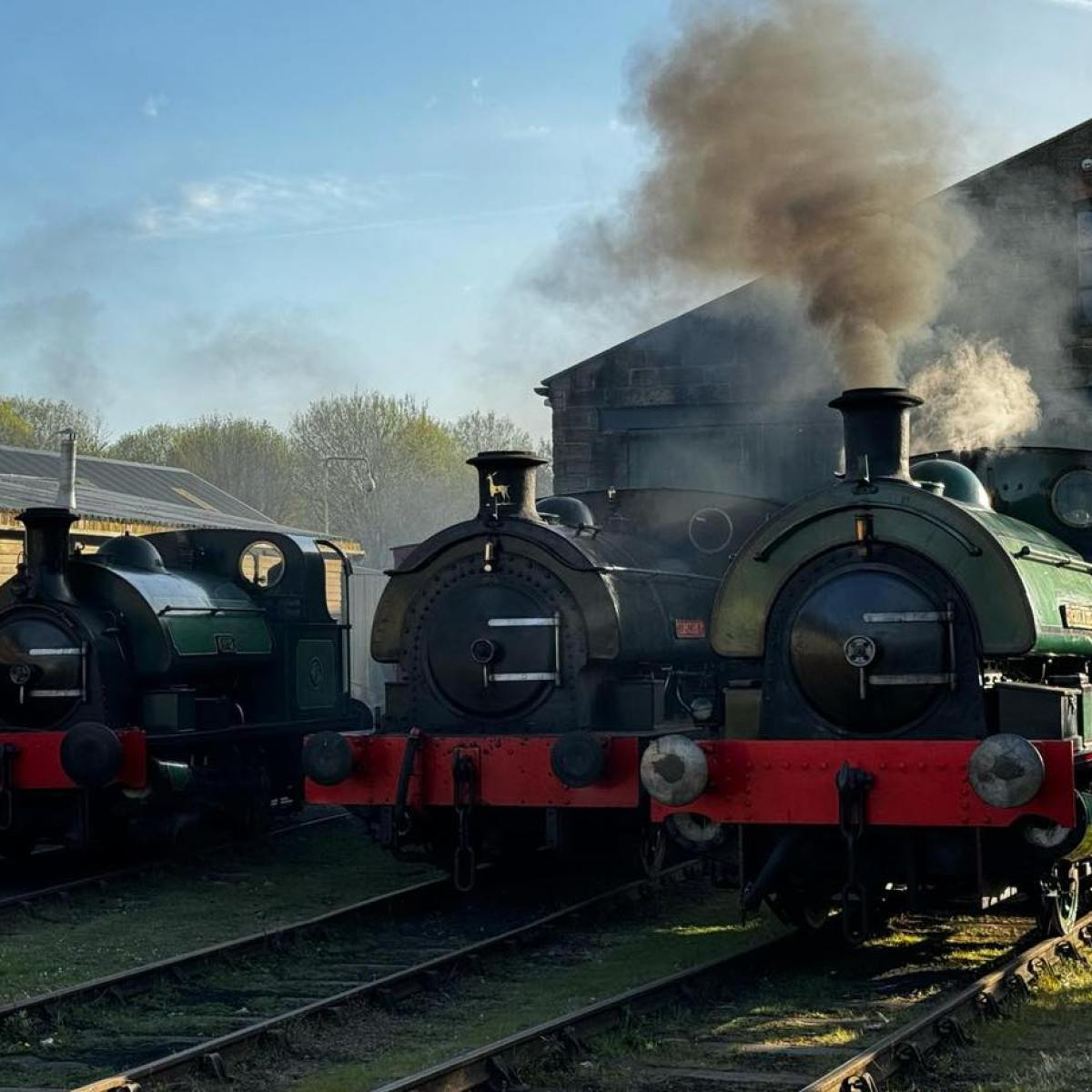 a steam train on a track with smoke coming out of it