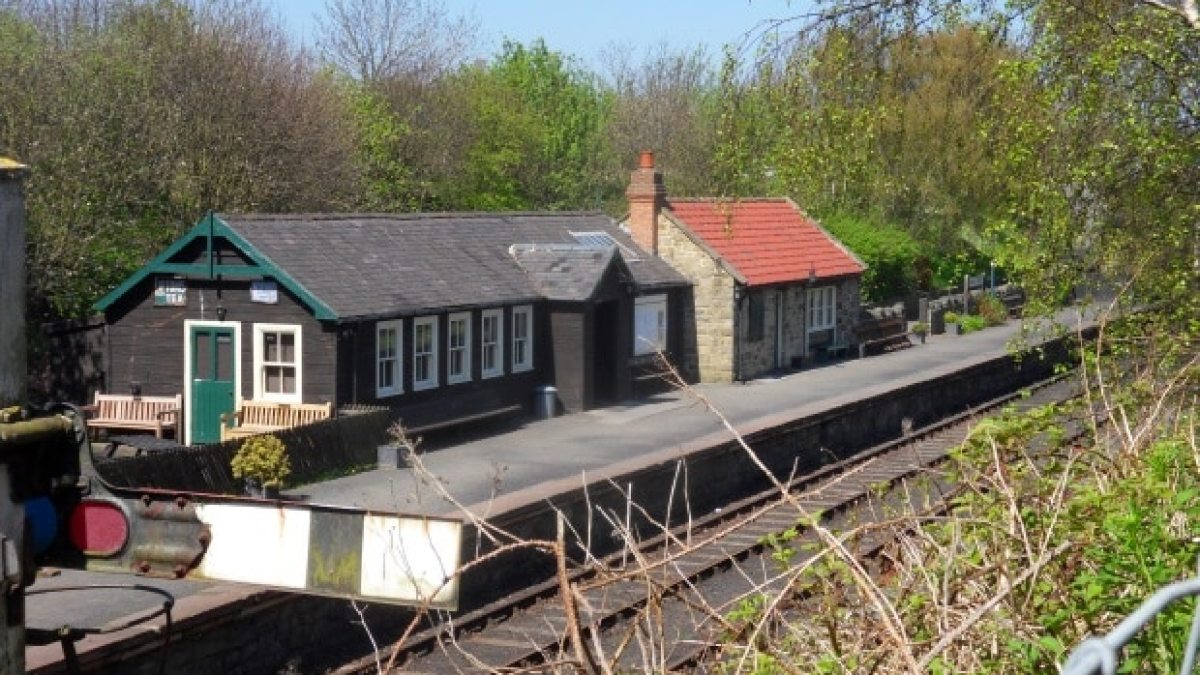 a train sitting on the side of a house