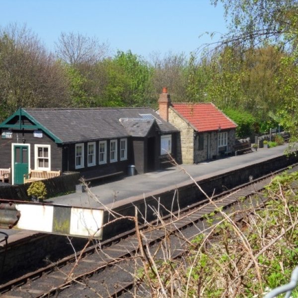 a train sitting on the side of a house