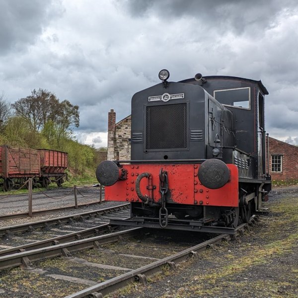 a train engine carrying carts down a track