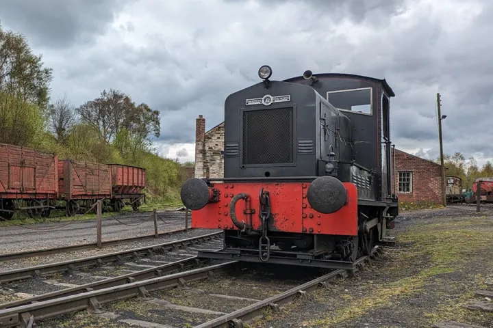 a train engine carrying carts down a track