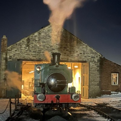 a train on a track with smoke coming out of it