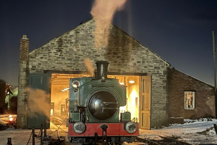 a train on a track with smoke coming out of it