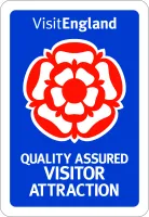 VisitEngland Quality Assured Visitor Attraction badge with red rose on blue background.