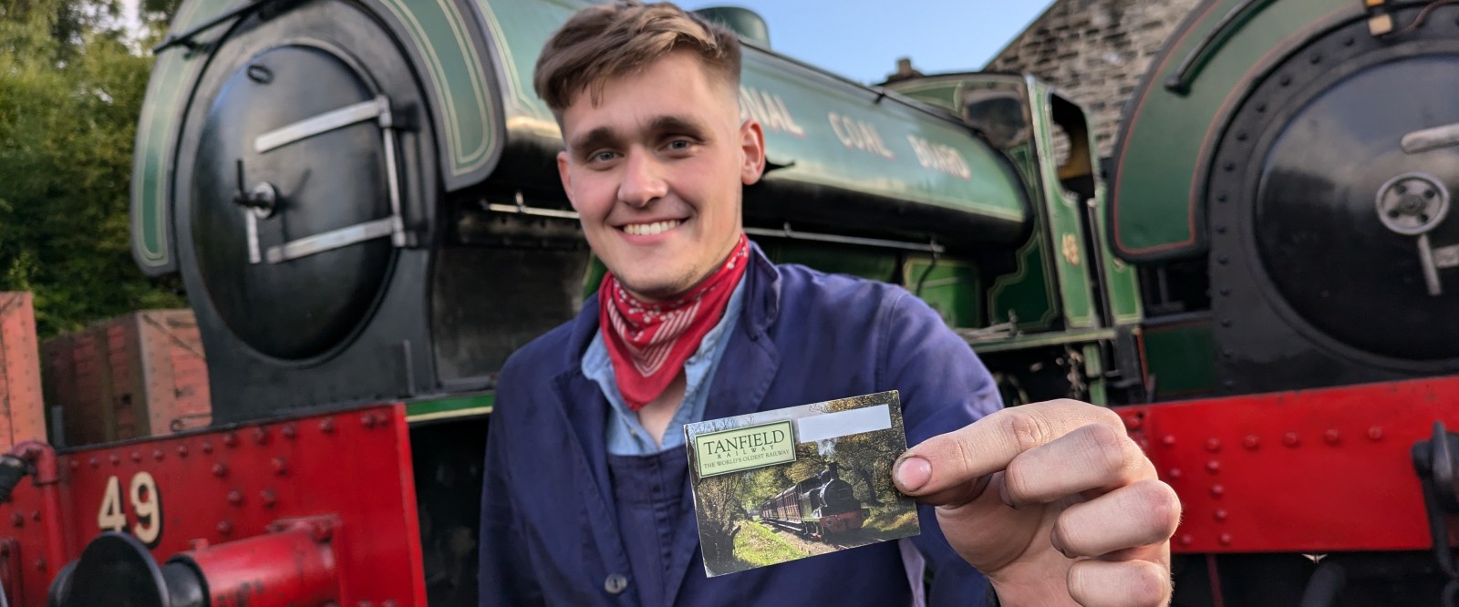 Tanfield Unlimited Ticket – landscape a person standing in front of train holding postcard