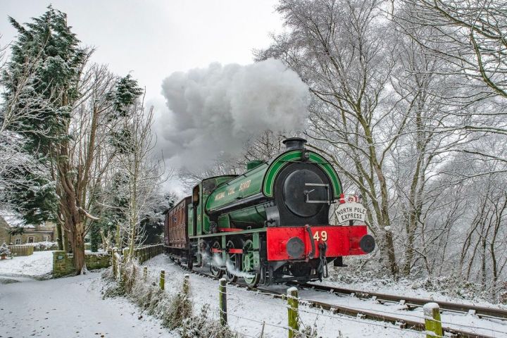 North Pole Express steam train travelling through a snow covered landscape