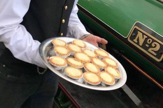 Person holding plate of mince pies