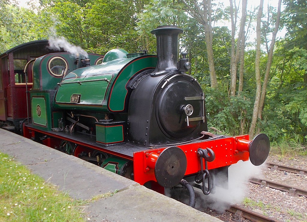 Keighley Gasworks No.2 Green and black steam locomotive on railroad tracks with trees in the background.